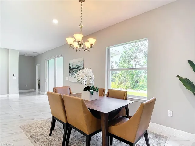 Dining space featuring a chandelier and light tile floors