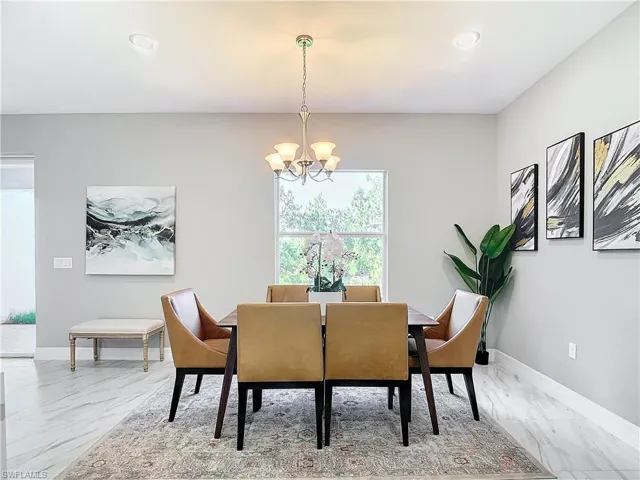 Tiled dining room with a notable chandelier