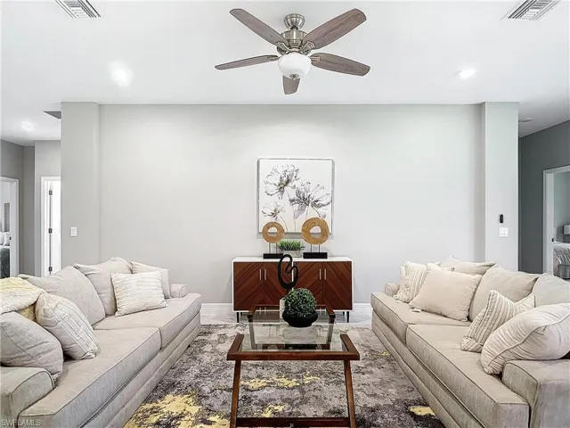 Living room with ceiling fan and wood-type flooring