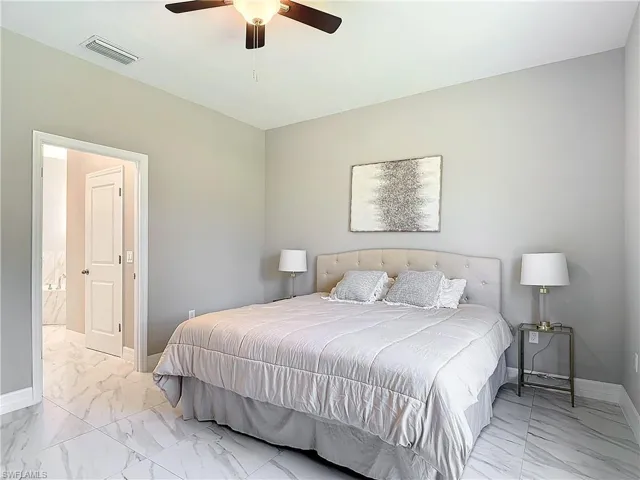 Tiled bedroom with ceiling fan