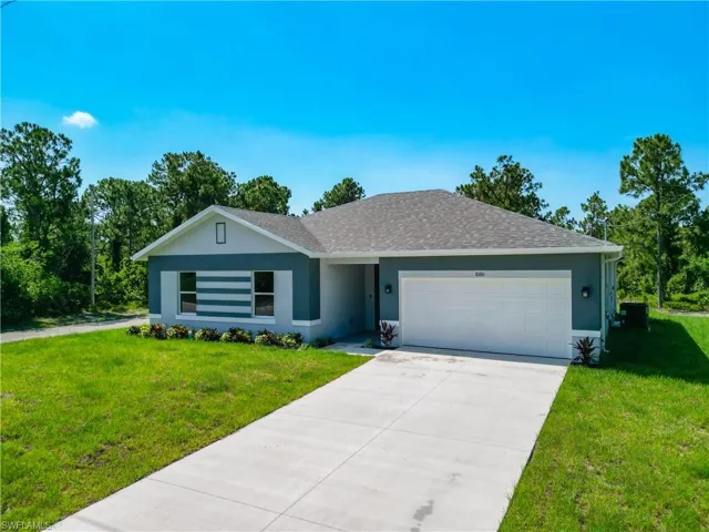 Single story home with a garage and a front yard