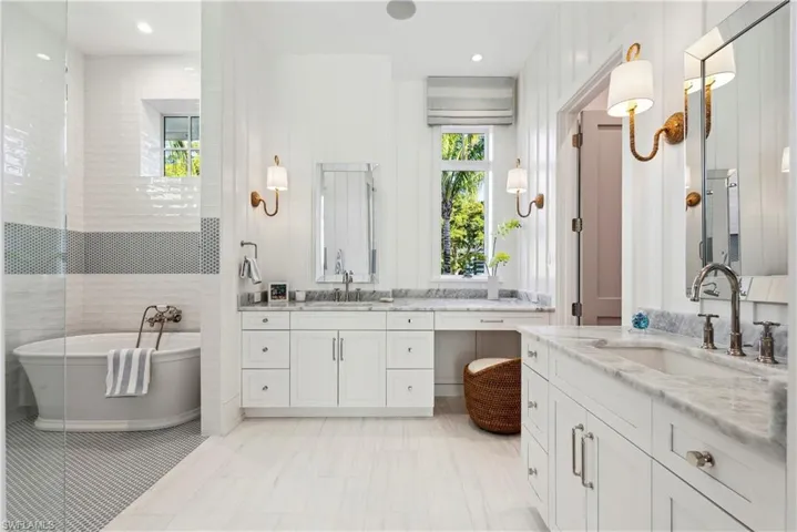 Bathroom with a tub to relax in and vanity