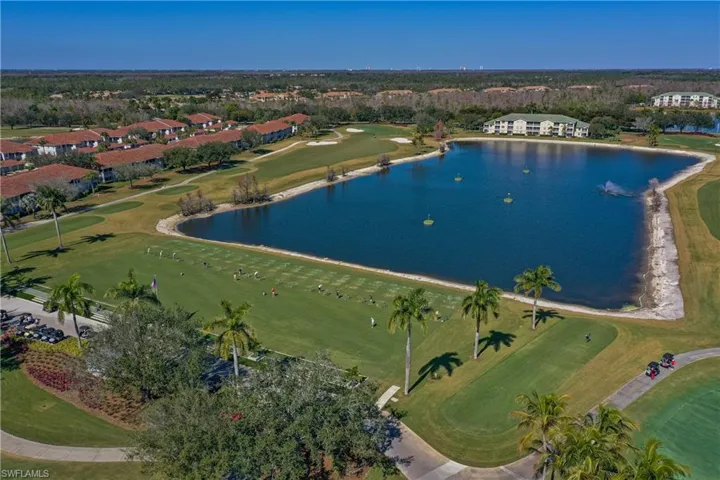 Aerial overview of property's location featuring a golf club and a nearby body of water