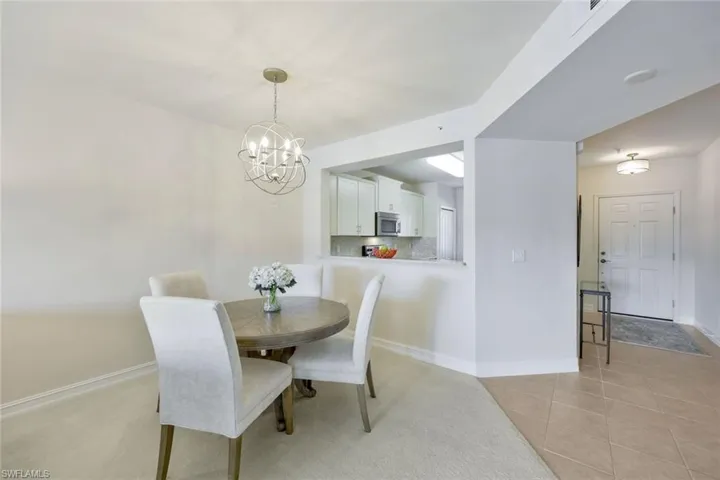 Tiled dining space with a notable chandelier