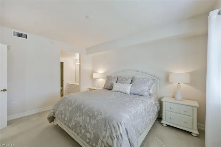 Bedroom with light colored carpet