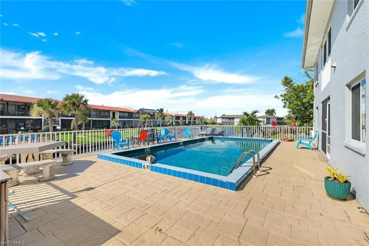 Swimming pool and white perimeter fencing