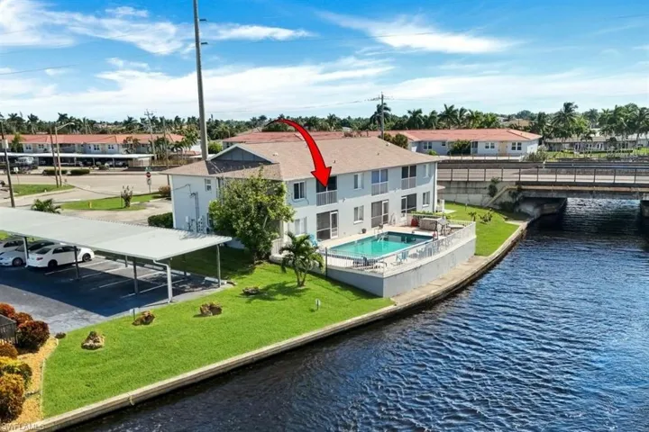 Waterfront canal setting, swimming pool, and upper-level balcony