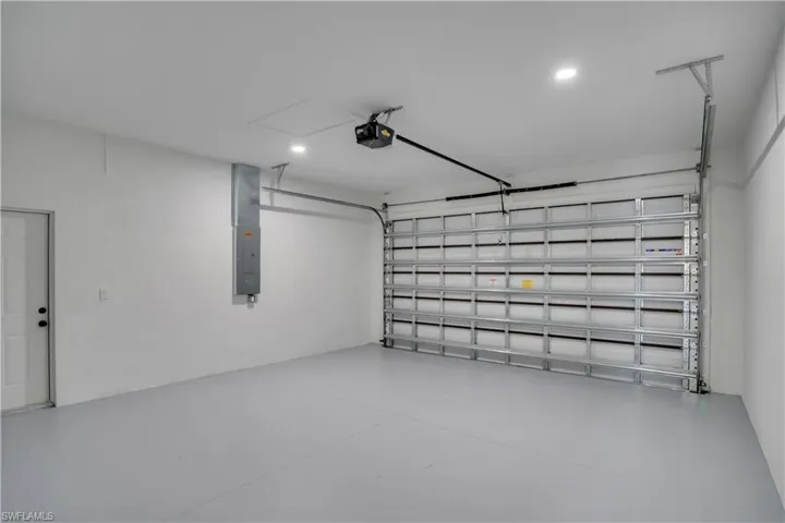Garage featuring a garage door opener