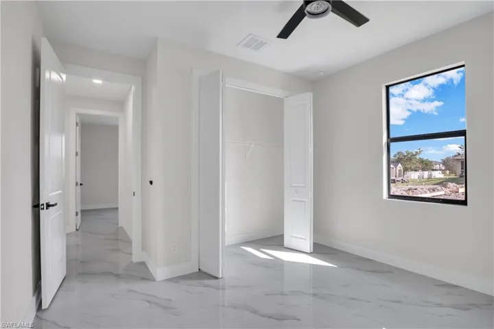Unfurnished bedroom featuring ceiling fan and a closet