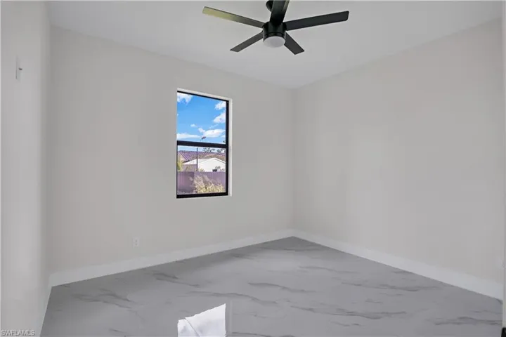 Unfurnished room featuring ceiling fan