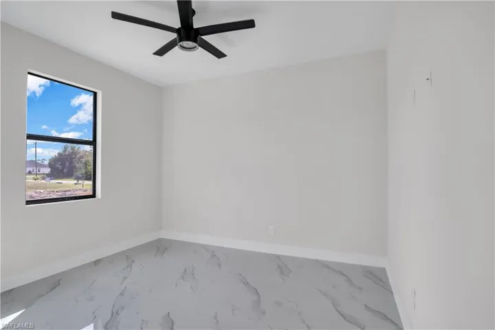 Spare room with ceiling fan