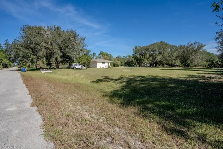 Adjoining cleared half-acre lot, also for sale.