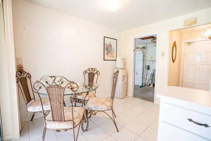 Eat-in kitchen with door leading to garage.