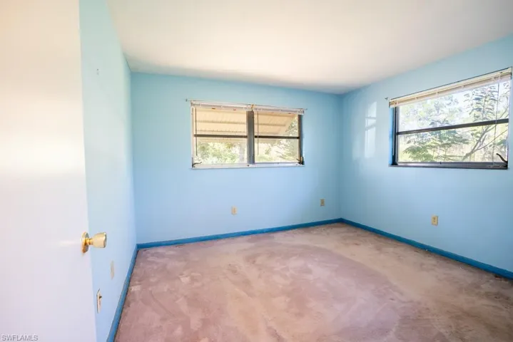 Guest bedroom with view to the back yard and large closet.
