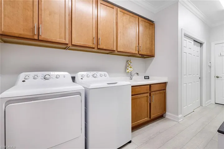 Laundry with cabinets and wash sink