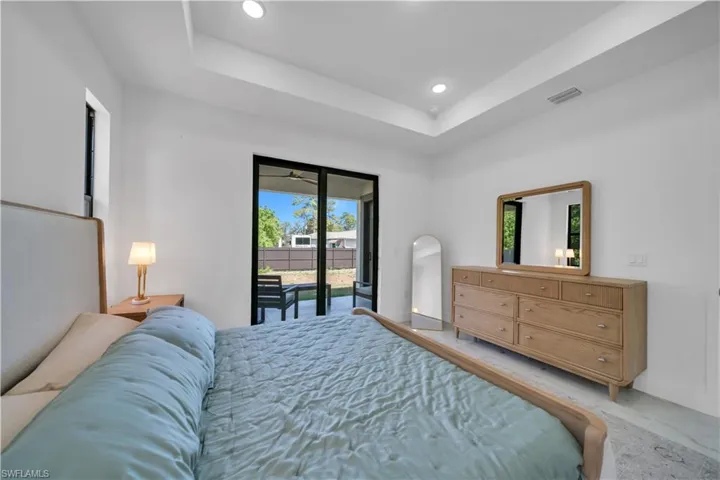 Interior room with white walls and a tray ceiling featuring recessed lighting