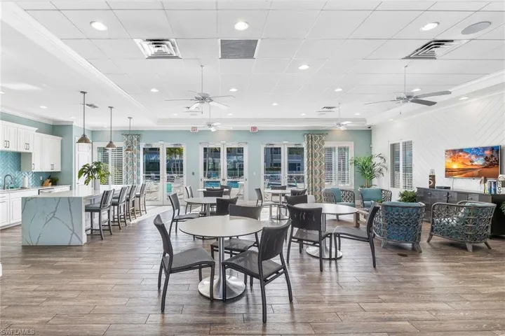 Club House dining area featuring ornamental molding, dark wood-style flooring