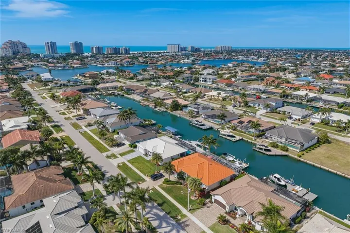 Aerial overview of property's location with a nearby body of water and nearby suburban area