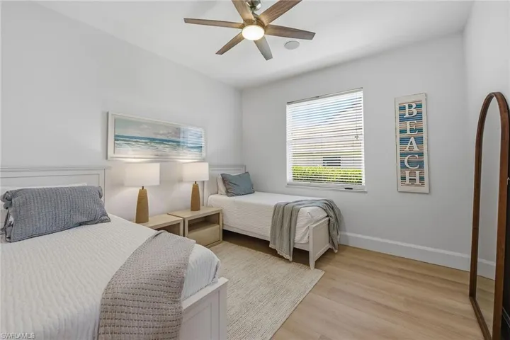 Bedroom with light wood-style floors and a ceiling fan
