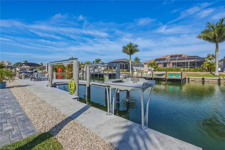 Dock with boat lift and a water view