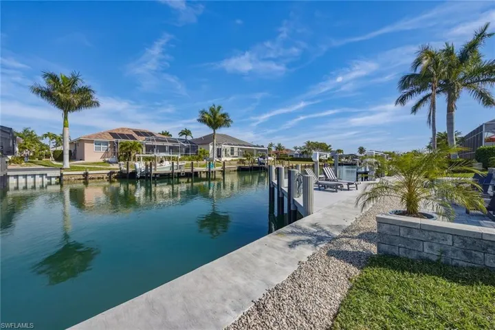 Dock featuring a water view, a residential view, and boat lift