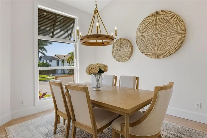 Dining space featuring light wood-type flooring and a chandelier
