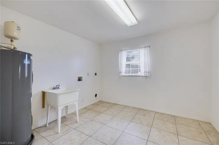 Laundry room featuring electric water heater, washer hookup, and hookup for an electric dryer