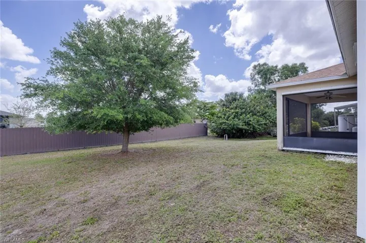 Fenced yard with a sunroom