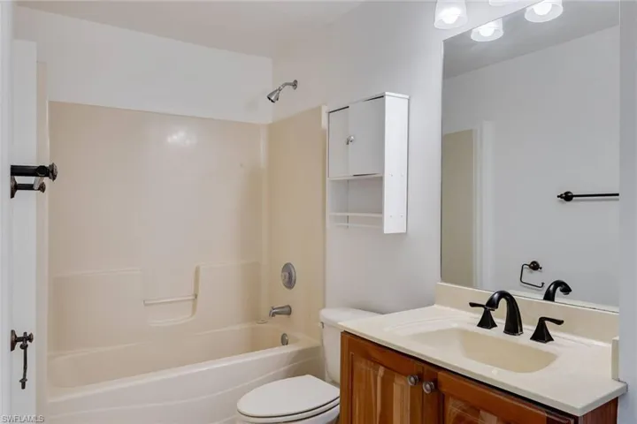 Bathroom featuring vanity and tub / shower combination
