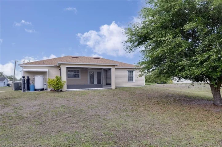 Rear view of house with a lawn and a patio area