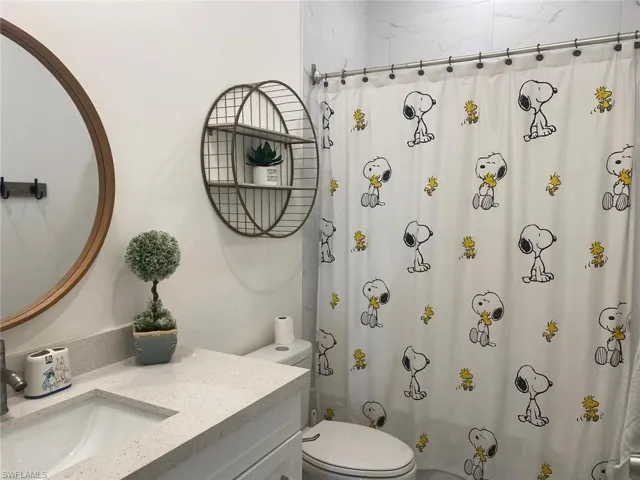 Bathroom featuring vanity and curtained shower