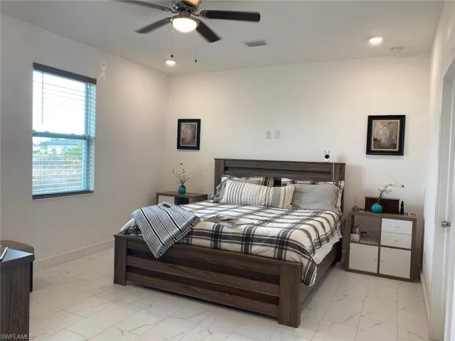 Bedroom with recessed lighting, baseboards, visible vents, and marble finish floor