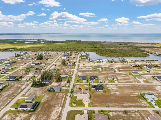Aerial perspective of suburban area with a nearby body of water