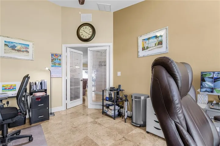 Office with baseboards and lofted ceiling