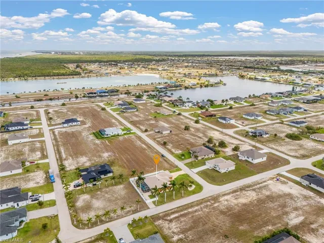 Aerial perspective of suburban area with a large body of water