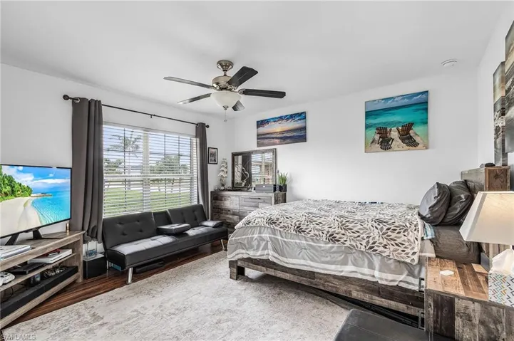 Bedroom with wood finished floors and ceiling fan