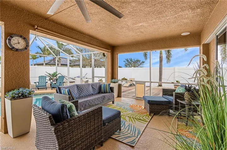 Sunroom / solarium with an outdoor lounge area, ceiling fan, and a patio area