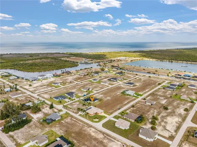 Aerial perspective of suburban area featuring a large body of water