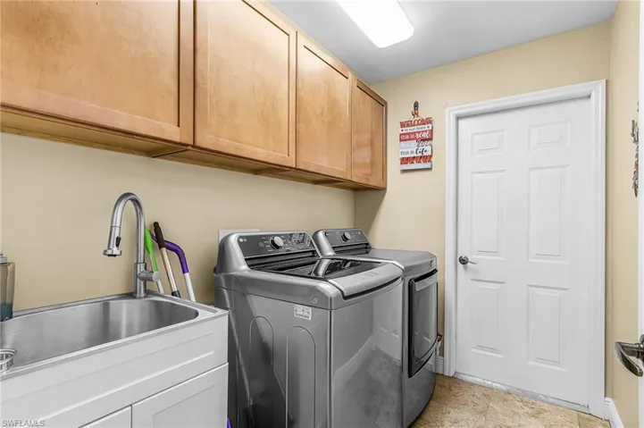 Laundry area featuring cabinet space and washer and dryer