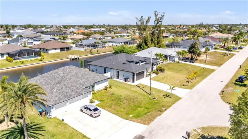 Canal-front property featuring a private dock and screened pool enclosure