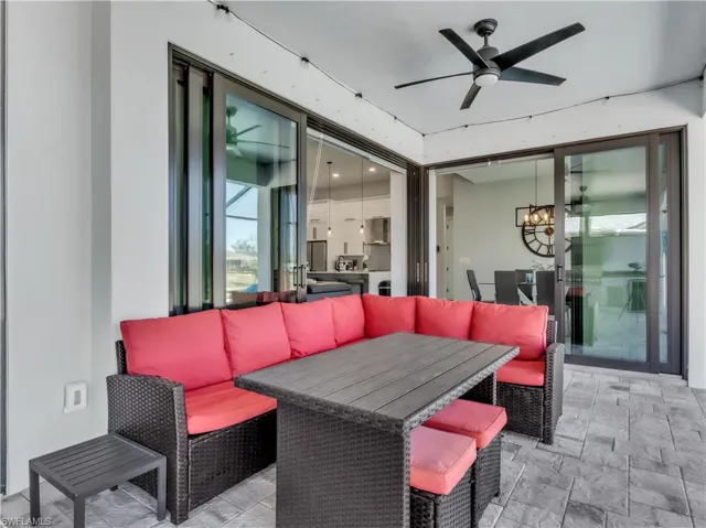 Covered outdoor patio featuring a ceiling fan, recessed lighting, and large sliding glass doors