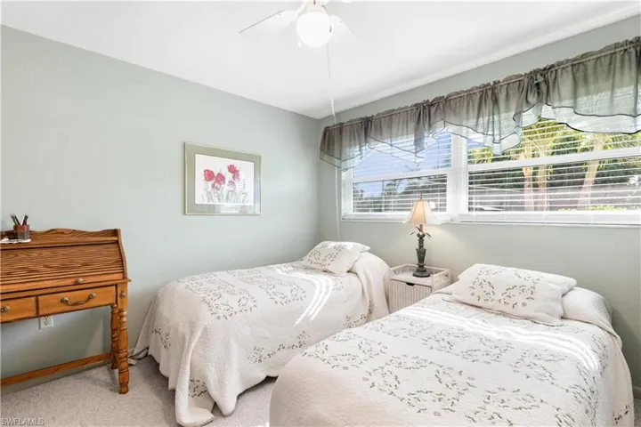 Bedroom featuring carpet floors, multiple windows, and ceiling fan