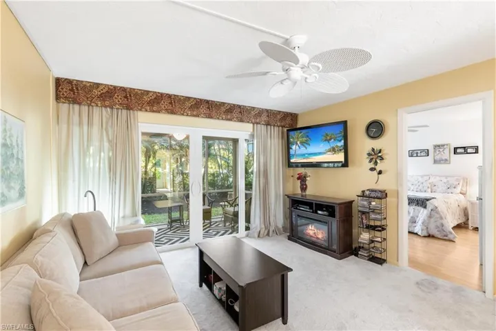 Living room with carpet, ceiling fan