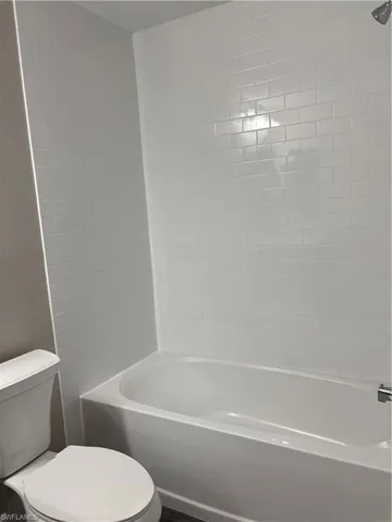 Full bath featuring tub / shower combination and toilet