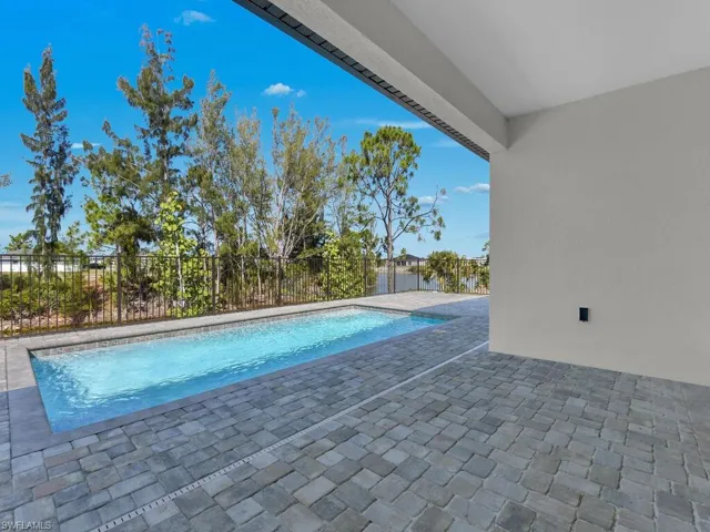 View of pool with fence, a fenced in pool, and a patio