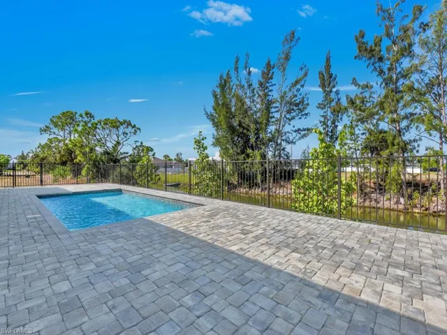 View of swimming pool featuring fence, a patio, and a fenced in pool