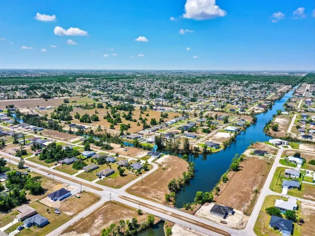 Birds eye view of property featuring a water view and a residential view