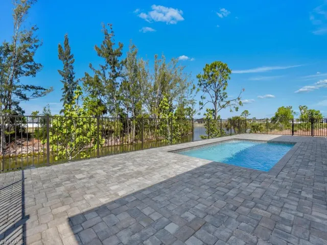 View of swimming pool featuring a fenced in pool, a patio, and fence