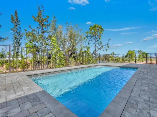 View of pool with a fenced in pool, a patio area, and fence