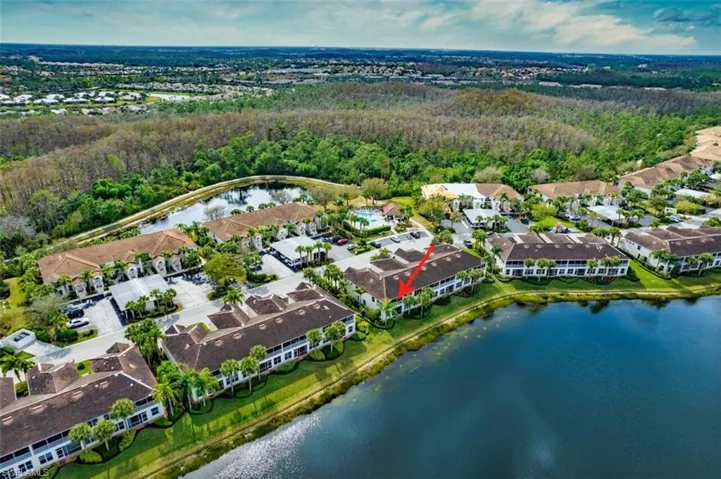 View of property location featuring a nearby body of water and nearby suburban area